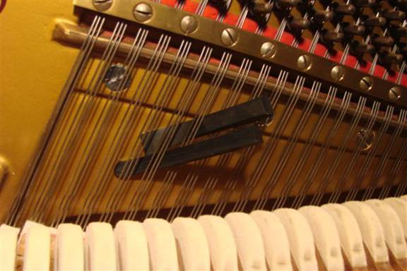 Muting of a three string string-set in the middle region (piano)