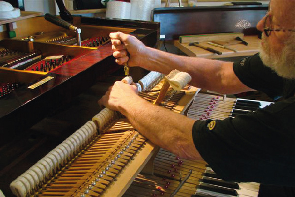 Working on a grand piano